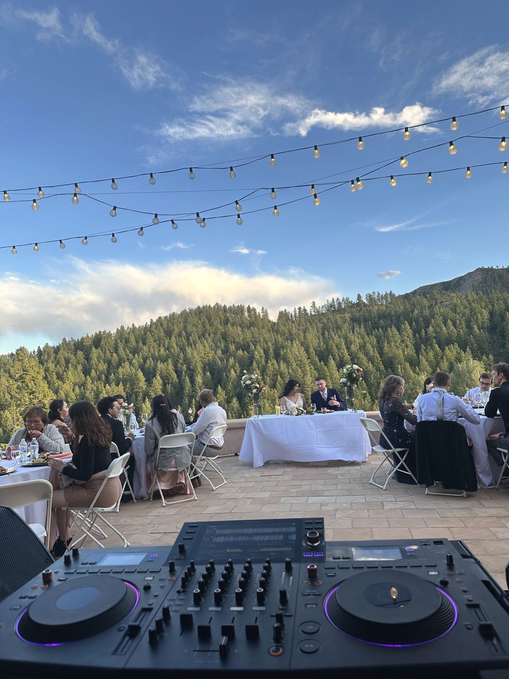 DJ decks in the foreground of a mountain wedding reception at Keyah Grande
