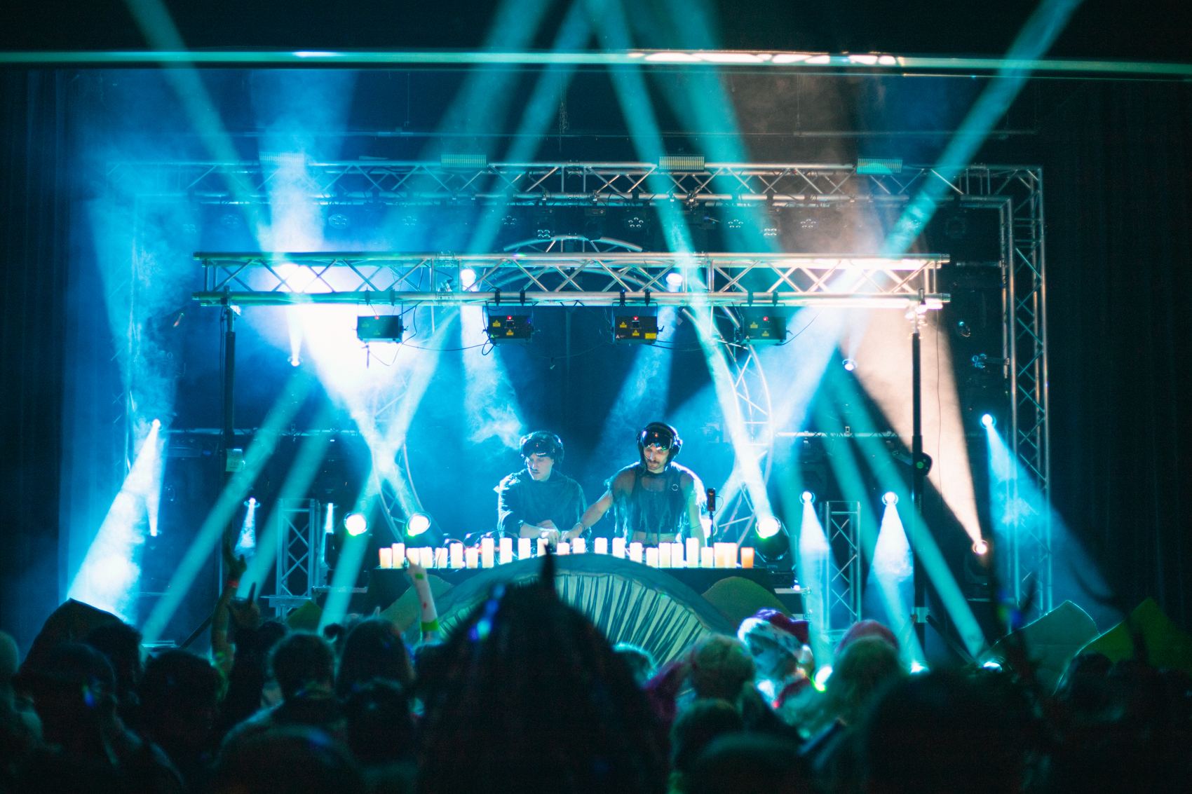 Ryan and Danny performing on a full production stage with a lighting rig and lasers